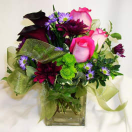 Bouquet of pink and purple flowers in a clear glass vase
