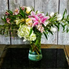 Pink lilies and white roses in a glass vase