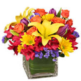Colorful mixed bouquet in a square glass vase