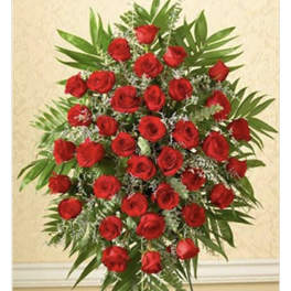 Standing spray of red roses with greenery