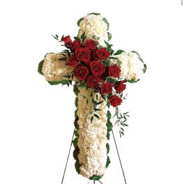 Cross-shaped floral tribute with red roses and white carnations