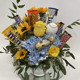 Bouquet of yellow roses and sunflowers with candy bars and a baseball