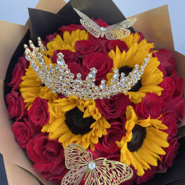 Bouquet of red roses and yellow sunflowers with jeweled butterfly accents