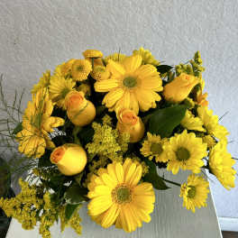 Yellow bouquet with gerbera daisies, roses, and small filler flowers