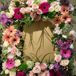 Large floral wreath with pink, white, and purple blooms