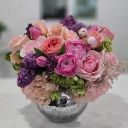 Pink and purple mixed bouquet in a silver vase