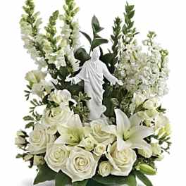 White floral arrangement with a small statue in the center