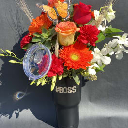 Bright mixed bouquet in a black tumbler with a clear lid and "#BOSS" text.
