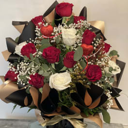 Bouquet of red and white roses with baby’s breath and heart picks