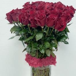 Bouquet of deep red roses in a clear glass vase