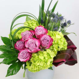 Pink roses and lime hydrangeas in a white vase