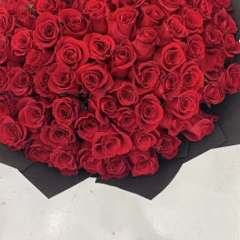 Large bouquet of red roses wrapped in black paper