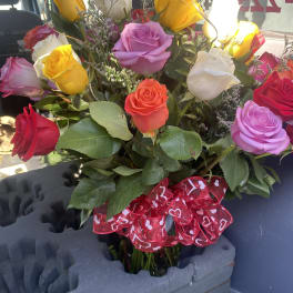 Bouquet of multicolored roses with a red heart ribbon