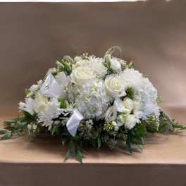 White floral casket spray with roses and chrysanthemums