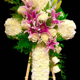 White and pink funeral spray on a wooden easel
