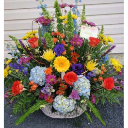 Large mixed flower basket with roses, hydrangeas, and daisies