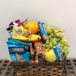Basket of fruit and snack packs on a table