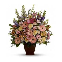 Large mixed flower arrangement in a dark vase