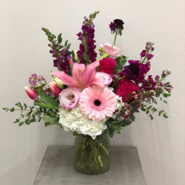 Pink and purple mixed bouquet in a glass vase