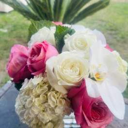 Bouquet of pink and white roses with a pale hydrangea cluster
