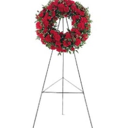 Red floral wreath on a metal easel