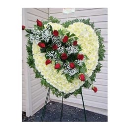 Heart-shaped standing floral spray with red roses and white flowers