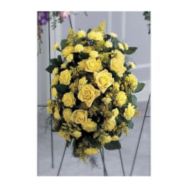 Yellow roses and carnations in a standing floral spray