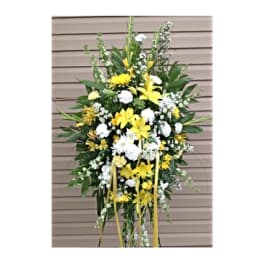 Tall yellow and white floral standing spray on an easel