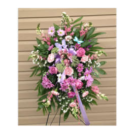 Standing floral spray with pink and purple flowers on an easel