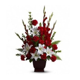 Red and white floral arrangement in a dark vase