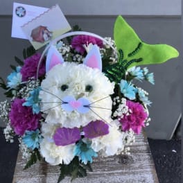 Cat-shaped floral arrangement with a green felt tail and ears