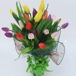 Bouquet of multicolored tulips wrapped with green ribbon