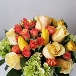 Mixed roses and tulips arranged in a glass vase
