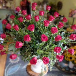 Bouquet of hot pink roses in a white vase