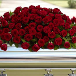 Large spray of red roses on a casket