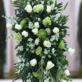 Tall white and green floral standing spray on an easel