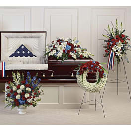 Funeral casket with patriotic floral sprays and wreaths