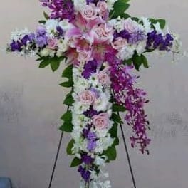 Cross-shaped floral standing spray with pink, white, and purple flowers