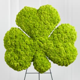 Bright green floral arrangement shaped like a flower on a stand