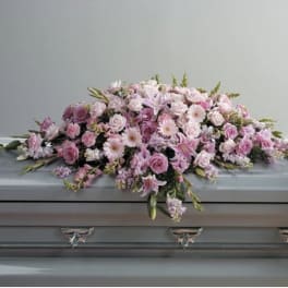 Pink floral casket spray with roses and lilies