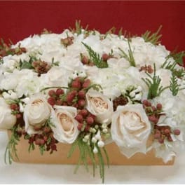 White rose arrangement in a rectangular box with red berries