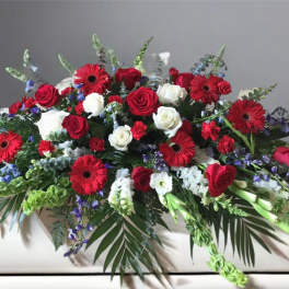 Large arrangement of red and white roses with red gerbera daisies
