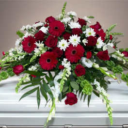 Red and white floral casket spray with roses and daisies