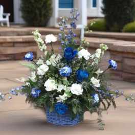 Blue and white floral arrangement in a blue basket