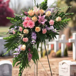 Standing floral spray with pink roses, lilies, and lavender blooms