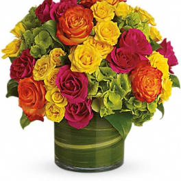 Bouquet of multicolored roses in a green glass vase