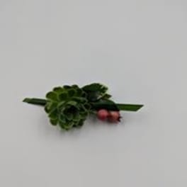 Small green floral boutonniere with two pink buds
