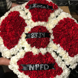 Red and white carnation wreath with black ribbons and silver lettering
