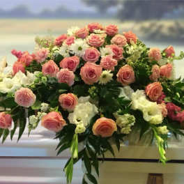 Large pink and white floral casket spray with roses and carnations