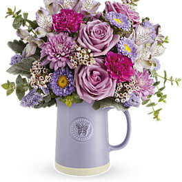 Lavender and pink mixed bouquet in a purple pitcher vase